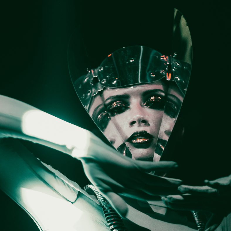 Live performer in costume with exotic mirror headpiece at Club Chinois