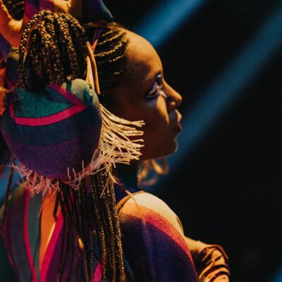 Performer in in Club Chinois wearing colourful clothes