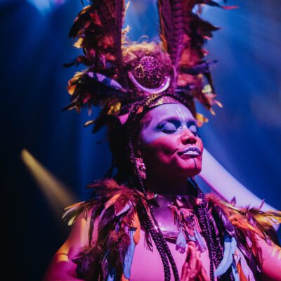 Performer with colourful headpiece in Club Chinois